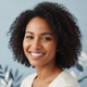 Portrait of a smiling young woman, conveying happiness and trust.